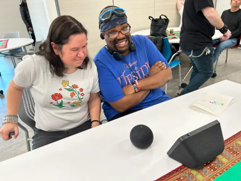 Rachel and Zach smiling while using Amazon Echo
