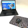 Mouse pad designed by Kevin C next to a laptop