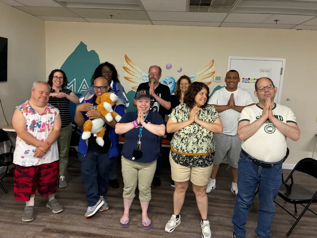 Group of people holding hands in prayer while one cuddles with an AI pet