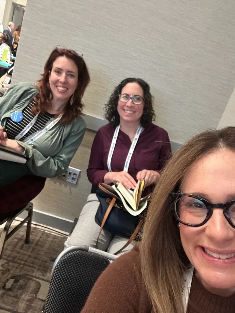 The Life Home Tech team smiling while waiting at the conference