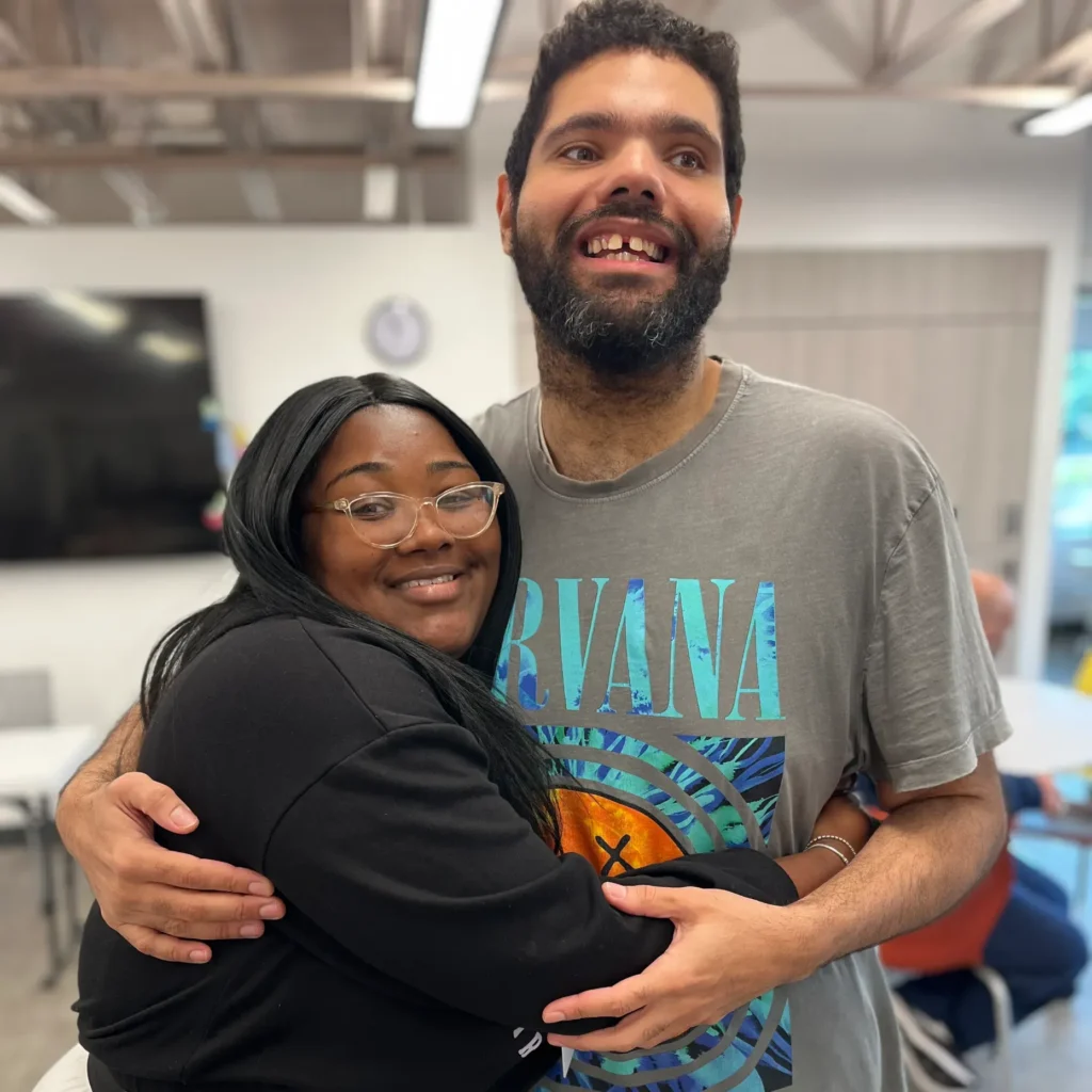 Jasmine hugging a WAE center member